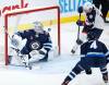 Columbus Blue Jackets’ Gustav Nyquist (14) scores on Winnipeg Jets goaltender David Rittich (33) as Neal Pionk (4) defends during the second period. (The Canadian Press / John Woods)