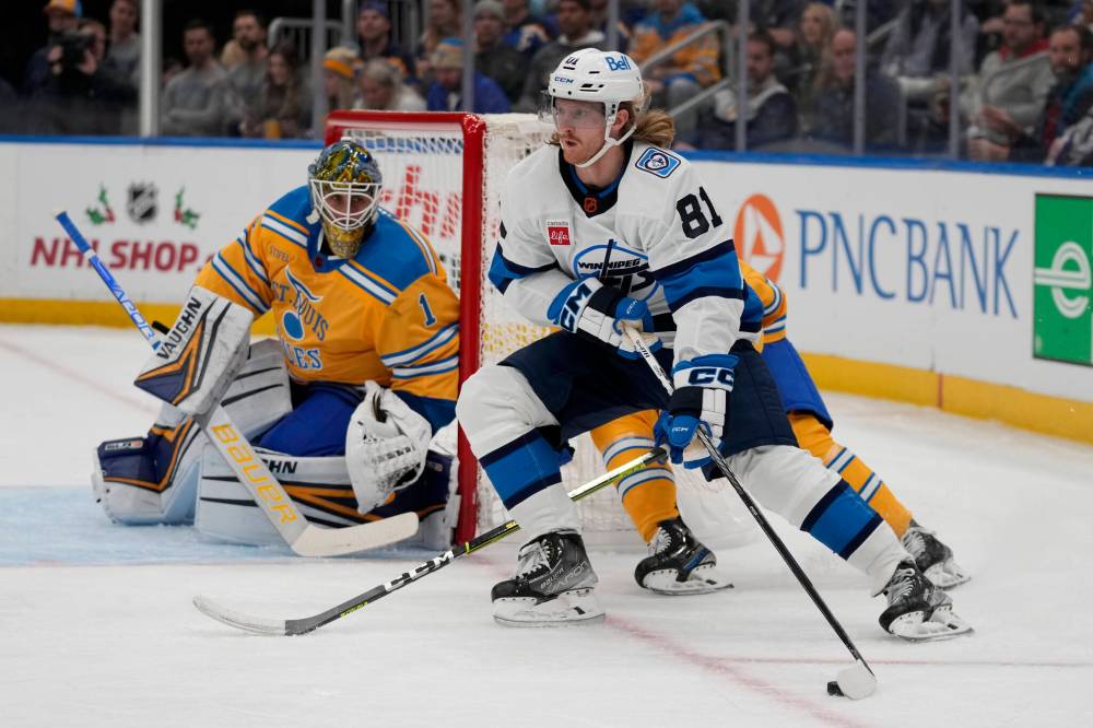 (AP Photo/Jeff Roberson)
                                Winnipeg Jets’ Kyle Connor handles the puck as St. Louis Blues goaltender Thomas Greiss defends during the first period Thursday in St. Louis.