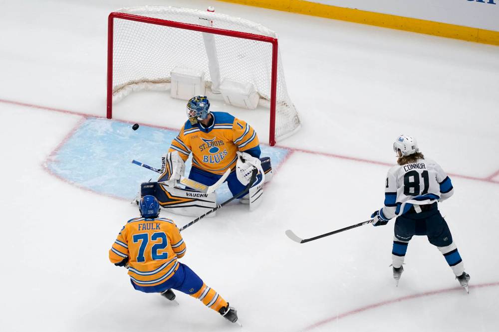 (AP Photo/Jeff Roberson)
                                Winnipeg Jets’ Kyle Connor scores past St. Louis Blues goaltender Thomas Greiss and Justin Faulk early in the second period Thursday in St. Louis.