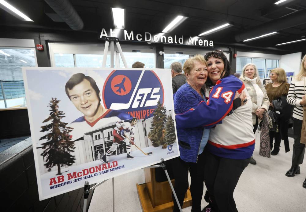 RUTH BONNEVILLE / WINNIPEG FREE PRESS 
                                Ab McDonald’s widow, Pat McDonald, and niece Karen Schultz, embrace at the arena renaming ceremony Friday at the St. James Civic Centre on Friday