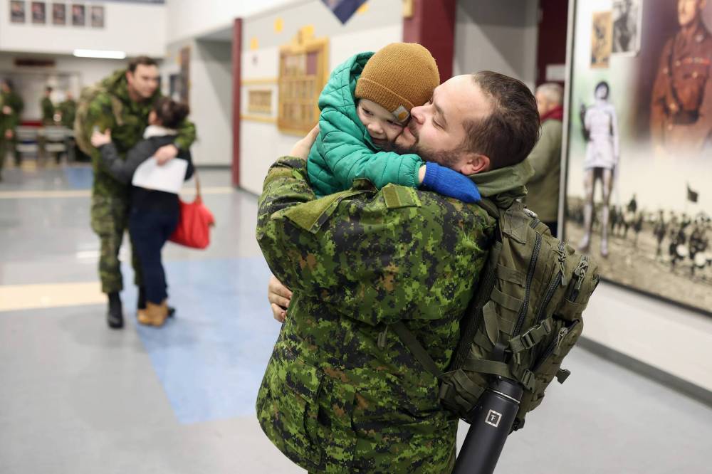 Tim Smith / Brandon Sun
Cpl. Michael Lesperance embraces his son Maverick, 3, after returning to CFB Shilo from Latvia late Thursday night.
08122022 Cpl Michael Lesperance hugs his son Maverick, three, after arriving back to CFB Shilo from Latvia late Thursday night along with fellow troops from 2PPCLI and the 1st Regiment, Royal Canadian Horse Artillery following a six month deployment as part of Operation Reassurance. Over 500 troops have been returning home from Shilo over the past few weeks with approximately 120 arriving home Thursday. Other troops from Shilo deployed to Latvia in recent days as part of the ongoing operation. (Tim Smith/The Brandon Sun)
