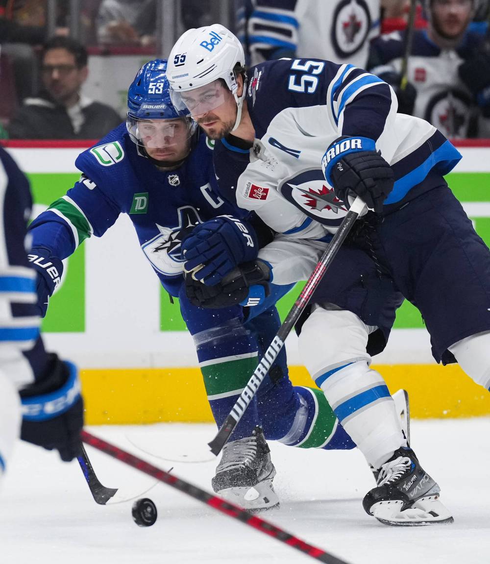 DARRYL DYCK / THE CANADIAN PRESS
Vancouver Canucks’ Bo Horvat (53) and Winnipeg Jets’ Mark Scheifele (55) vie for the puck during the first period.