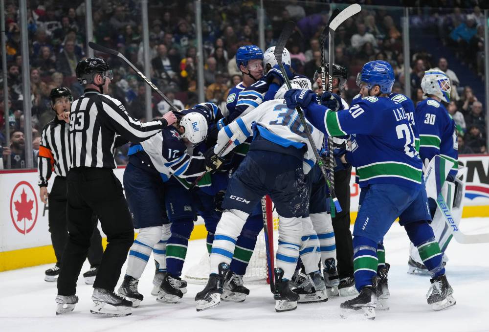 DARRYL DYCK / THE CANADIAN PRESS
Vancouver Canucks’ Tyler Myers (57) grabs Winnipeg Jets’ Adam Lowry (17) as the teams get into a scuffle after the whistle during the second period.