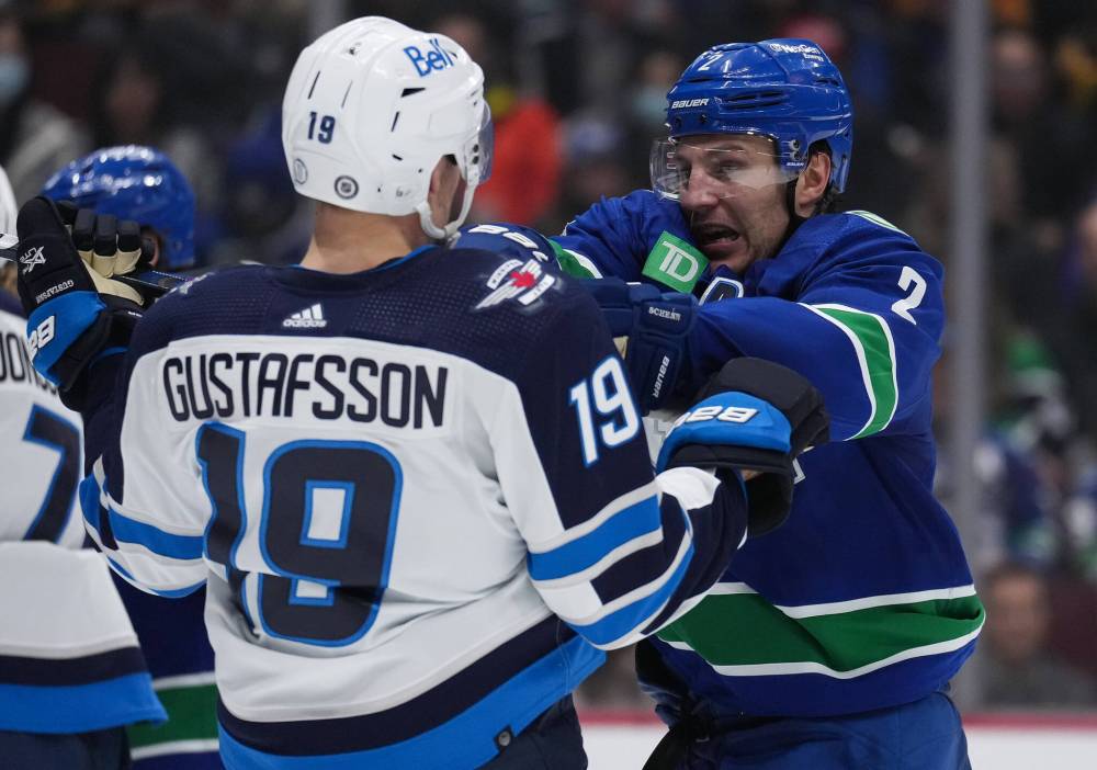 DARRYL DYCK / THE CANADIAN PRESS
Vancouver Canucks’ Luke Schenn, back right, shoves Winnipeg Jets’ David Gustafsson, of Sweden, during the second period.