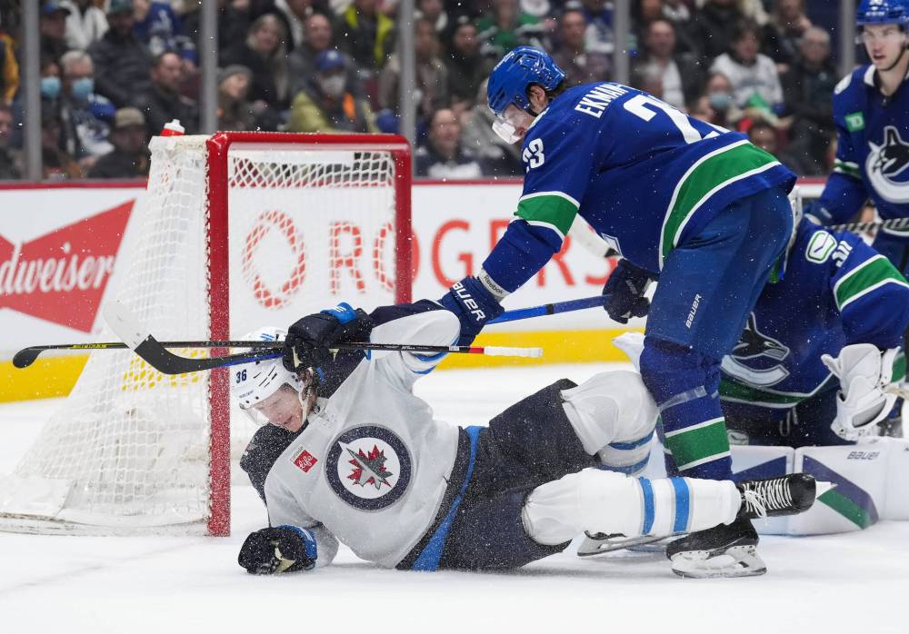 DARRYL DYCK / THE CANADIAN PRESS
Vancouver Canucks’ Oliver Ekman-Larsson (23), of Sweden, checks Winnipeg Jets’ Morgan Barron (36) during the second period.