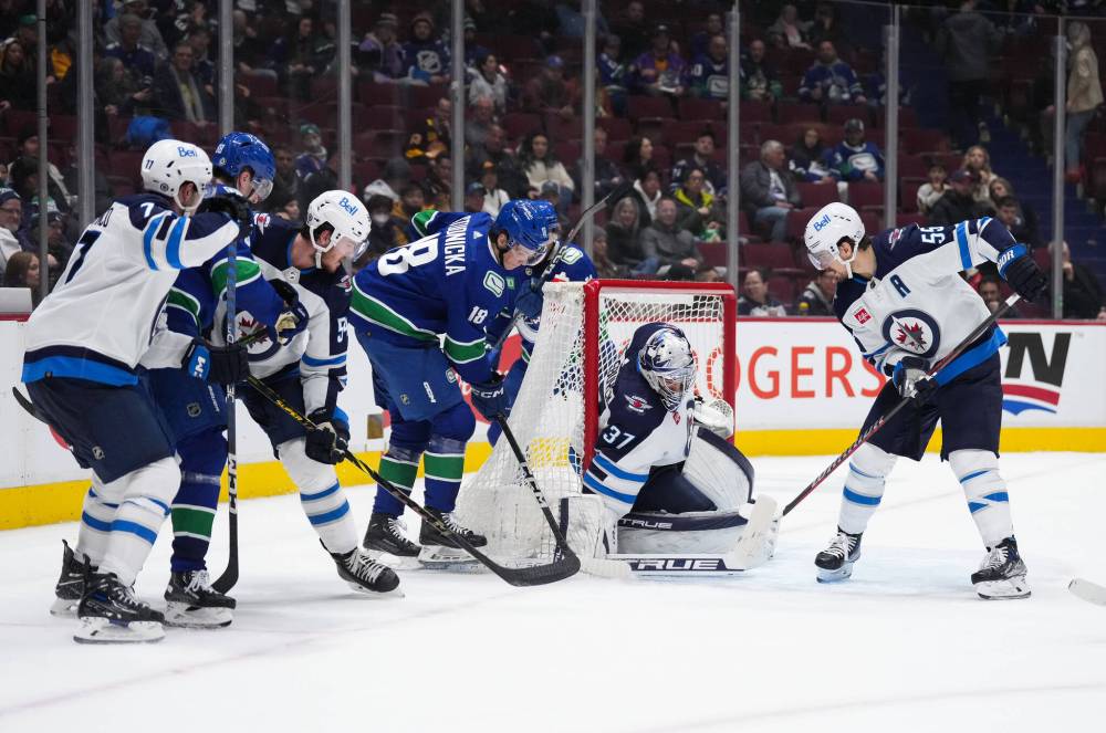 DARRYL DYCK / THE CANADIAN PRESS
Winnipeg Jets goalie Connor Hellebuyck (37) stops Vancouver Canucks’ Jack Studnicka (18) during the third period.