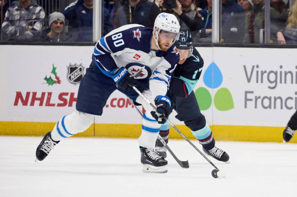 JOHN FROSCHAUER / THE ASSOCIATED PRESS
Winnipeg Jets left wing Pierre-Luc Dubois (80) skates with the puck while Seattle Kraken center Jaden Schwartz (17) defends during the first period.