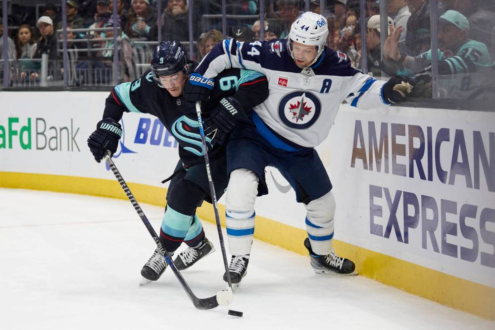 JOHN FROSCHAUER / THE ASSOCIATED PRESS
Seattle Kraken center Ryan Donato (9) vies for the puck with Winnipeg Jets defenseman Josh Morrissey (44) during the second period.