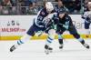 JOHN FROSCHAUER / THE ASSOCIATED PRESS
                                Winnipeg Jets center Kevin Stenlund (28) and Seattle Kraken left wing Andre Burakovsky (95) vie for the puck during the third period of an NHL hockey game, Sunday, Dec. 18, 2022, in Seattle.