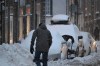 A man shovels his car out of a street parking space as a major storm hits Eastern Canada on Friday, December 23, 2022 in Quebec City. THE CANADIAN PRESS/Jacques Boissinot