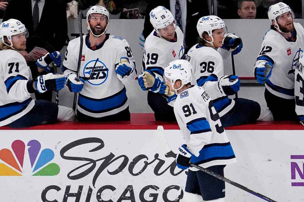 Cole Perfetti (91) is congratulated for his goal against the Chicago Blackhawks during the first period.  (Nam Y. Huh / The Associated Press)