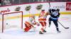 Sam Gagner deflects a Ville Heinola shot past Calgary goaltender Jacob Markstrom for the winning goal in the third period on Tuesday. (Fred Greenslade / The Canadian Press)