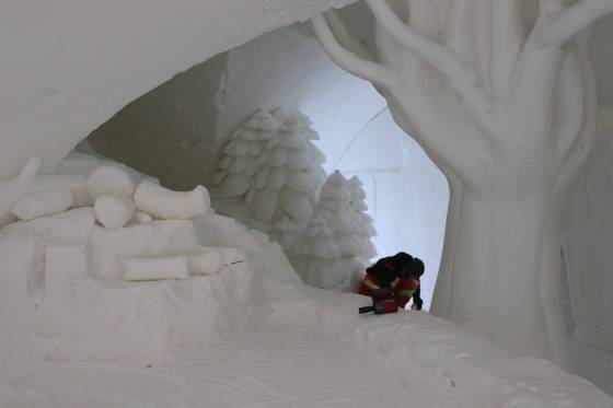 A worker puts finishing touches on the snow maze in St. Adolphe, which measures nearly 60,000 square feet and contains five buildings and a variety of sculptures constructed from snow. (Tyler Searle / Winnipeg Free Press)