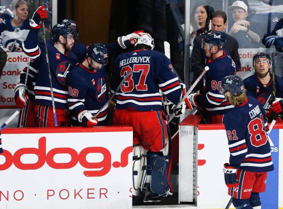 Winnipeg Jets goaltender Connor Hellebuyck (37) is taken out of the game during the third period against the Philadelphia Flyers in Winnipeg, Saturday. (John Woods / The Canadian Press)