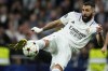 FILE - Real Madrid's Karim Benzema kicks the ball during the Champions League Group F soccer match between Real Madrid and Celtic at the Santiago Bernabeu stadium in Madrid, Spain, Nov. 2, 2022. Barcelona and Real Madrid resume their fight for the Spanish league title as the competition starts again following a seven-week hiatus for the World Cup. Barcelona has a two-point lead and hosts Espanyol at Camp Nou on Saturday Dec. 31, 2022, a day before defending champion Madrid visits Valladolid. (AP Photo/Manu Fernandez, File)