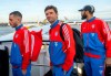Thomas Mueller, center, and Eric Maxim Choupo-Moting, right, players of the Bundesliga soccer team FC Bayern Munich, board a plane at the airport in Munich, Gemany, Friday, Jan. 6, 2023. The Bayern Munich team flies to Qatar on Friday for its winter training camp amid uncertainty over the club’s contentious sponsorship agreement with the Persian Gulf country. (Peter Kneffel/dpa via AP)