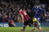 Chelsea's Christian Pulisic, right, duels for the ball with Bournemouth's Lewis Cook during the English Premier League soccer match between Chelsea and Bournemouth at Stamford Bridge Stadium in London, Tuesday, Dec. 27, 2022. (AP Photo/Kin Cheung)