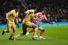 Atletico Madrid's Joao Felix, right, challenges for the ball with Barcelona's Pedri, left, and Alejandro Balde during the Spanish La Liga soccer match between Atletico Madrid and FC Barcelona at Civitas Metropolitano stadium in Madrid, Spain, Sunday, Jan. 8, 2023. (AP Photo/Manu Fernandez)