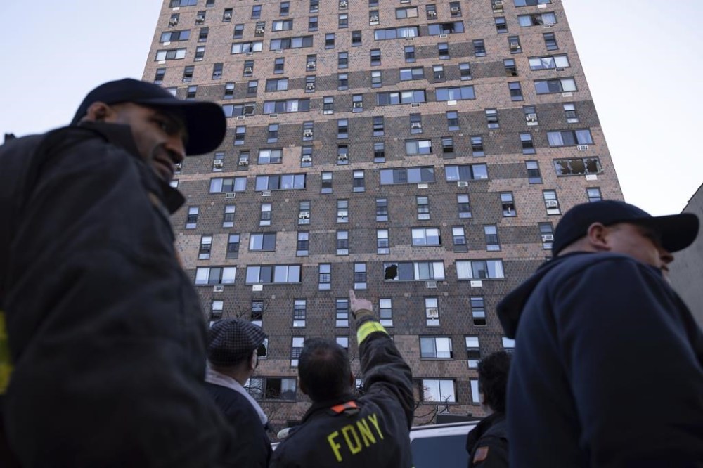 FILE - Firefighters work outside the apartment building in the Bronx on Monday, Jan. 10, 2022, in New York. Fires feeding off modern materials found in people's homes are burning faster and becoming more deadly at the same time that fire departments across the country are struggling to retain and recruit firefighters, officials said Thursday, Jan. 12, 2023. (AP Photo/Yuki Iwamura, File)