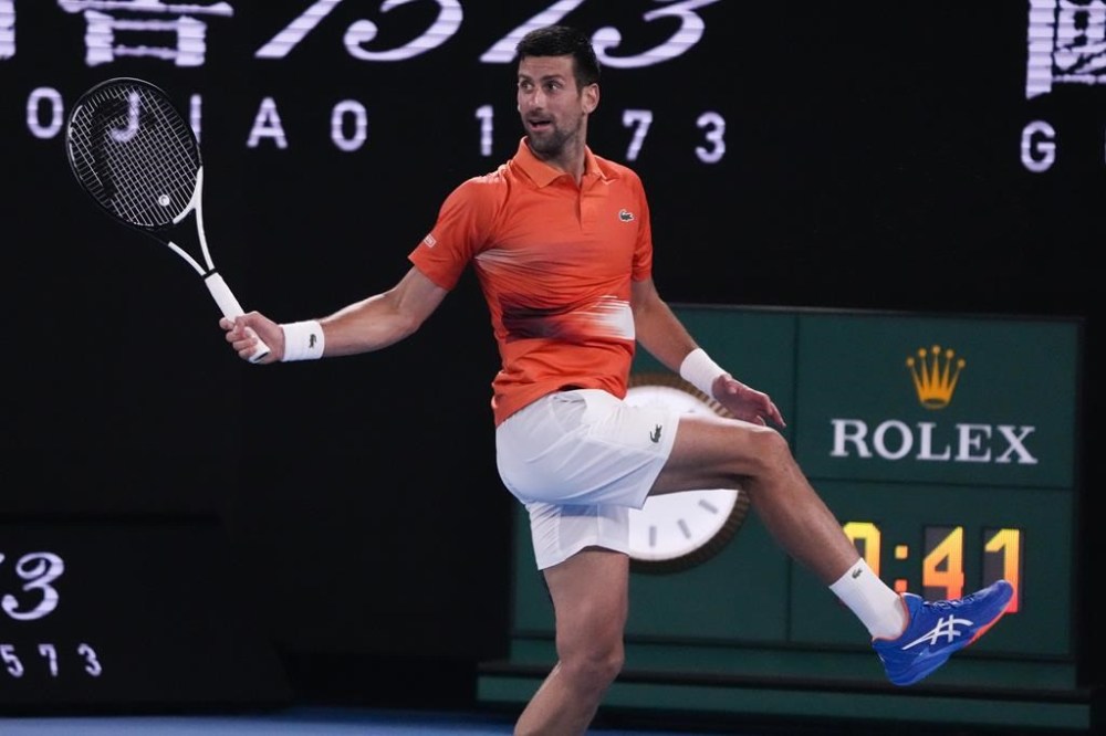 Serbia's Novak Djokovic returns a shot to Australia's Nick Kyrgios during an exhibition match on Rod Laver Arena ahead of the Australian Open tennis championship in Melbourne, Australia, Friday, Jan. 13, 2023. (AP Photo/Mark Baker)