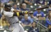 FILE - Pittsburgh Pirates' Andrew McCutchen hits his 200th career home run during the first inning of a baseball game against the Milwaukee Brewers, Wednesday, Sept. 13, 2017, in Milwaukee. McCutchen is returning to the Pirates. A person with knowledge of the agreement tells the Associated Press the veteran centerfielder, a five-time All-Star and the 2013 National League MVP for the Pirates earlier in his career, has agreed to a one-year deal with the club.(AP Photo/Morry Gash, File)