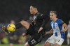 Arsenal's William Saliba, left, vies for the ball with Brighton's Leandro Trossard during the English Premier League soccer match between Brighton and Hove Albion and Arsenal and at the AMEX Community Stadium in Brighton, England, Saturday, Dec. 31, 2022. (AP Photo/Alastair Grant)