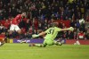 Manchester United's Marcus Rashford, left, scores his side's third goal past Charlton's goalkeeper Ashley Maynard-Brewer during the English League Cup quarter final soccer match between Manchester United and Charlton Athletic at Old Trafford in Manchester, England, Tuesday, Jan. 10, 2023. (AP Photo/Dave Thompson)