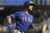 FILE - Texas Rangers' Nathaniel Lowe runs toward home after hitting a home run during the eighth inning of the team's baseball game against the Minnesota Twins, Aug. 21, 2022, in Minneapolis. Lowe and pitchers Taylor Hearn, Jonathan Hernández and Brett Martin agreed to one-year contracts Friday, Jan. 13, with the Rangers, avoiding salary arbitration. (AP Photo/Stacy Bengs, File)