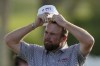 Shane Lowry of Ireland and The Great Britain and Ireland Team, reacts on 18th hole during the afternoon foursomes on Day Two of the Hero Cup at Abu Dhabi Golf Club, in Abu Dhabi, United Arab Emirates, Saturday, Jan. 14, 2023. (AP Photo/Kamran Jebreili)