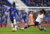 Chelsea's Kadeisha Buchanan, left is tackled by Tottenham Hotspur's Asmita Ale during the Women's Super League soccer match between Chelsea and Tottenham Hotspur, at Stamford Bridge, London, Sunday, Nov. 20, 2022. THE CANADIAN PRESS/AP-John Walton/PA via AP