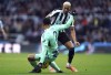 Newcastle United's Joelinton (right) and Fulham's Kenny Tete battle for the ball, during the English Premier League soccer match between Newcastle United and Fulham, at St. James' Park, Newcastle, England, Sunday Jan. 15, 2023. (Owen Humphreys/PA via AP)
