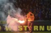 FILE - A steward removes a flare which was thrown onto the pitch at the end of the first leg quarterfinal Europa League soccer match between Club Brugge and FC Dnipro Dnipropetrovsk at Jan Breydel stadium in Bruges, Belgium, Thursday April 16, 2015. More than 1,800 stadium bans and fines above 900,000 euros ($974,000) have been imposed on hooligans who committed violence during the 2021-22 season in Belgium, local enforcement authorities said on Tuesday, Jan. 17, 2023. (AP Photo/Geert Vanden Wijngaert, File)