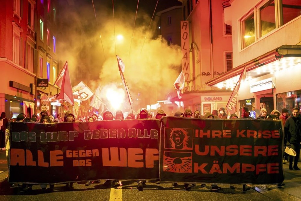 Protesters hold a banner reading