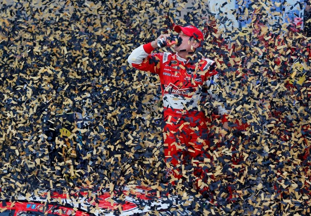 FILE - Driver Kevin Harvick celebrates in victory lane after winning the NASCAR Sprint Cup series auto race at Kansas Speedway in Kansas City, Kan., Sunday, Oct. 6, 2013. Kevin Harvick said Thursday, Jan. 12, 2023, he will retire from NASCAR competition at the end of the 2023 season. (AP Photo/Orlin Wagner, File)