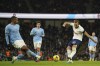 Tottenham's Harry Kane, right, attempts a shot at goal in front of Manchester City's Manuel Akanji during the English Premier League soccer match between Manchester City and Tottenham Hotspur at the Etihad Stadium in Manchester, England, Thursday, Jan. 19, 2023. (AP Photo/Dave Thompson)