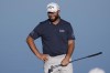 Jon Rahm smiles as he stands on the ninth green during the American Express golf tournament on the Nicklaus Tournament Course at PGA West Friday, Jan. 20, 2023, in La Quinta, Calif. (AP Photo/Mark J. Terrill)