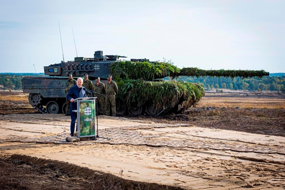 FILE - German Chancellor Olaf Scholz speaks to soldiers in front of a Leopard 2 main battle tank after the Army's training and instruction exercise in Ostenholz, Germany, Monday, oct. 17, 2022. Germany has become one of Ukraine's leading weapons suppliers in the 11 months since Russia's invasion. The debate among allies about the merits of sending battle tanks to Ukraine has focused the spotlight relentlessly on Germany, whose Leopard 2 tank is used by many other countries and has long been sought by Kyiv. (Moritz Frankenberg/dpa via AP, FILE)