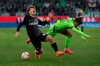 Freiburg's Ritsu Doan, left, and Wolfsburg's Paulo Otavio challenge for the ball during the German Bundesliga soccer match between VfL Wolfsburg and SC Freiburg in Wolfsburg, Germany, Saturday, Jan. 21, 2023. (Swen Pfoertner/dpa via AP)