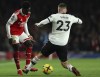 Arsenal's Bukayo Saka, left, duels for the ball with Manchester United's Luke Shaw during the English Premier League soccer match between Arsenal and Manchester United at Emirates stadium in London, Sunday, Jan. 22, 2023. (AP Photo/Ian Walton)