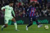 Barcelona's Ousmane Dembele, right, passes with the ball past Getafe's Omar Alderete during a Spanish La Liga soccer match between Barcelona and Getafe at the Camp Nou stadium in Barcelona, Spain, Sunday, Jan. 22, 2023. (AP Photo/Joan Monfort)