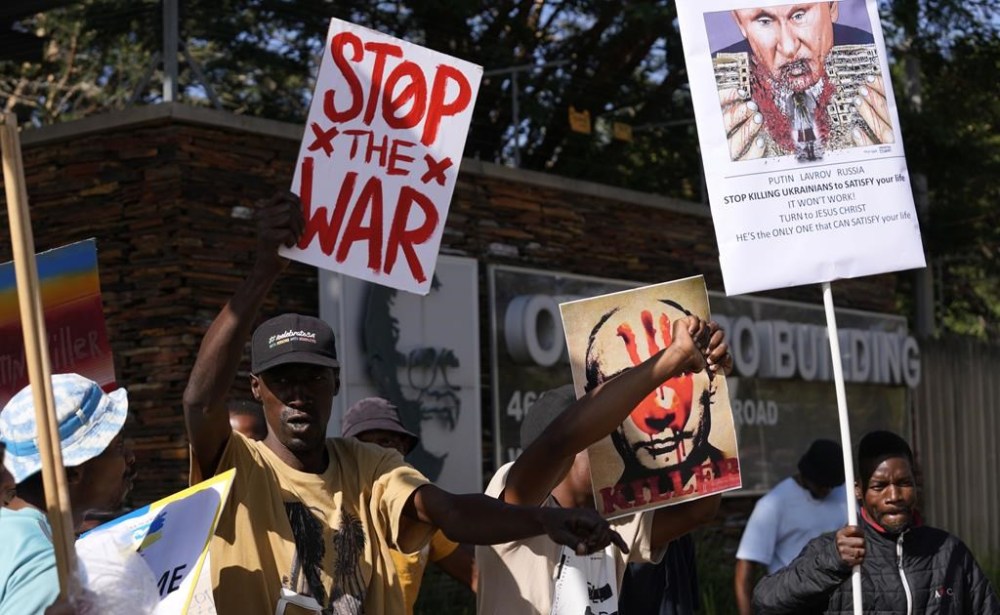 People supporting Ukraine picket against Russia's Foreign Minister Sergey Lavrov outside the Dirco (OR Tambo) Building in Pretoria, South Africa, Monday, Jan. 23, 2023. Lavrov arrived in South Africa for diplomatic talks with his counterpart amid heightened global tensions over the country's war with Ukraine. (AP Photo/Themba Hadebe)