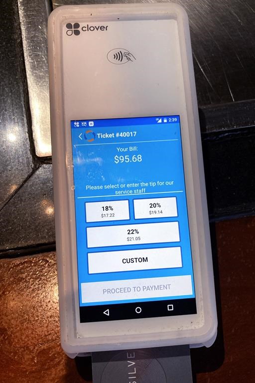 A tipping option is displayed on a card reader at a restaurant in Schaumburg, Ill., Tuesday, Jan. 10, 2023. Tipping fatigue, it seems, is swarming America as more businesses adopt digital payment methods that automatically prompts customers to leave a gratuity. (AP Photo/Nam Y. Huh)