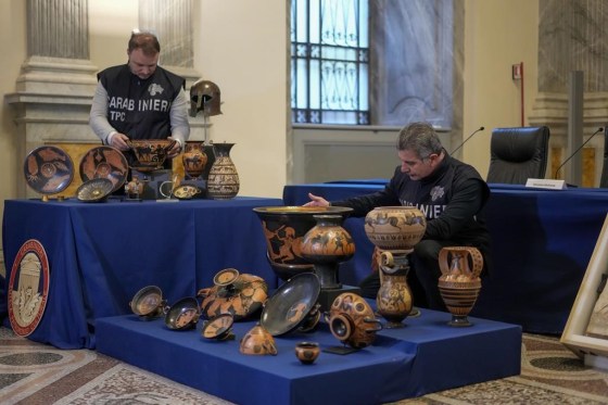 Carabinieri police officers put on display 60 archaeological artifacts stolen from Italy and sold in the U.S. (Andrew Medichini / The Associated Press)