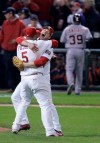 FILE - St. Louis Cardinals Scott Rolen and teammate Albert Pujols celebrate as Detroit Tigers Ramon Santiago walks off the field after the St. Louis Cardinals defeated Detroit Tigers in Game 5 of the World Series in St. Louis, Oct. 27, 2006. Rolen could become just the 18th third baseman elected to baseball's Hall of Fame, the fewest of any position. Rolen, Todd Helton and Billy Wagner are the leading contenders in the Baseball Writers' Association of America vote announced Tuesday, Jan. 24, 2023.(AP Photo/Tom Gannam, File)