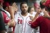 FILE -Cincinnati Reds' Tommy Pham (28) celebrates with teammates after scoring on a Donovan Solano double during the third inning of a baseball game against the Miami Marlins, Monday, July 25, 2022, in Cincinnati. The New York Mets signed veteran outfielder Tommy Pham to a one-year contract Tuesday, Jan. 24, 2023, adding to their busy offseason. (AP Photo/Jeff Dean, File)