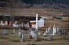 A cemetery and a boarded-up abandoned building are seen on the former grounds of St. Joseph's Mission residential School, in Williams Lake, B.C., on Wednesday, March 30, 2022. Williams Lake First Nation in central British Columbia is ready to announce results from the second phase of an investigation of grounds around the school, where 93 