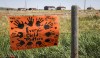 A sign commemorating victims of residential schools is attached to a fence line in front of homes east of Calgary near Gliechen, Alta., Tuesday, June 29, 2021. A new report from a group looking into children that died and went missing at an Alberta residential school says unpasteurized milk was responsible for the deaths of Indigenous children at the institution. THE CANADIAN PRESS/Jeff McIntosh