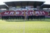 FILE - Britain's King Charles III and Camilla, the Queen Consort meet Wrexham Soccer team co owners, US actors Ryan Reynolds and Rob McElhenney and players during their visit to Wrexham Association Football Club's Racecourse Ground, in Wrexham, England, Friday, Dec. 9, 2022. The Hollywood owners of Wrexham are still learning the vernacular of British soccer. They don’t need any advice, though, in setting the scene for this weekend’s FA Cup match against second-division Sheffield United. (Arthur Edwards/Pool Photo via AP, File)