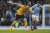Wolverhampton Wanderers' Nathan Collins, left, is challenged by Manchester City's Julian Alvarez during the English Premier League soccer match between Manchester City and Wolverhampton at the Etihad Stadium in Manchester, England, Sunday, Jan. 22, 2023. (AP Photo/Dave Thompson)