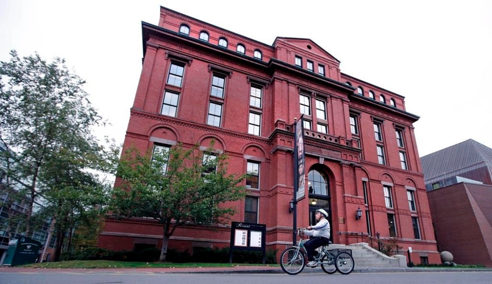 A cyclist rolls past the Peabody Museum of Archaeology & Ethnology at Harvard University in Cambridge, Mass., on October 13, 2016. After 138 years, including two decades in storage, a house post will be returned to a First Naiton in British Columbia from Harvard University. The house post was bought by a fishing company in 1885 and has been part of the museum's anthropological artifacts since 1917. THE CANADIAN PRESS/AP, Charles Krupa